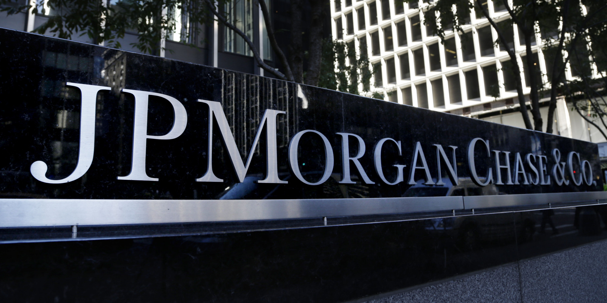 The JPMorgan Chase & Co. logo is displayed at their headquarters in New York, Monday, Oct. 21, 2013. JPMorgan Chase & Co. has tentatively agreed to pay $13 billion to settle allegations surrounding the quality of mortgage-backed securities it sold in the run-up to the 2008 financial crisis, a person familiar with the negotiations between the bank and the federal government said Saturday. (AP Photo/Seth Wenig)